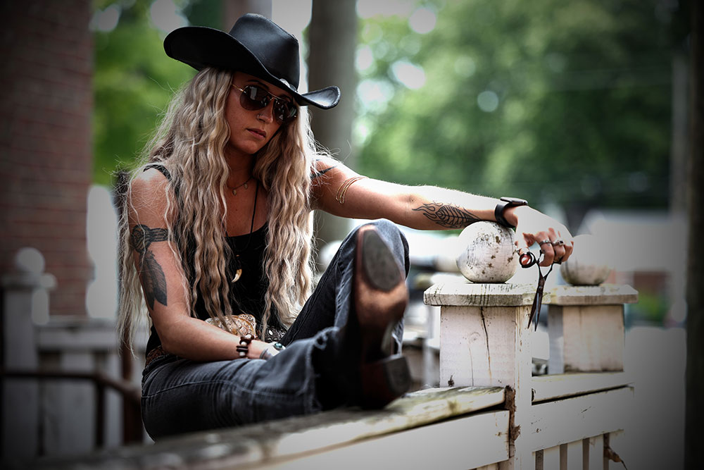 Ren Faith wearing the black cowboy hat -the origin of Black Hat Barber